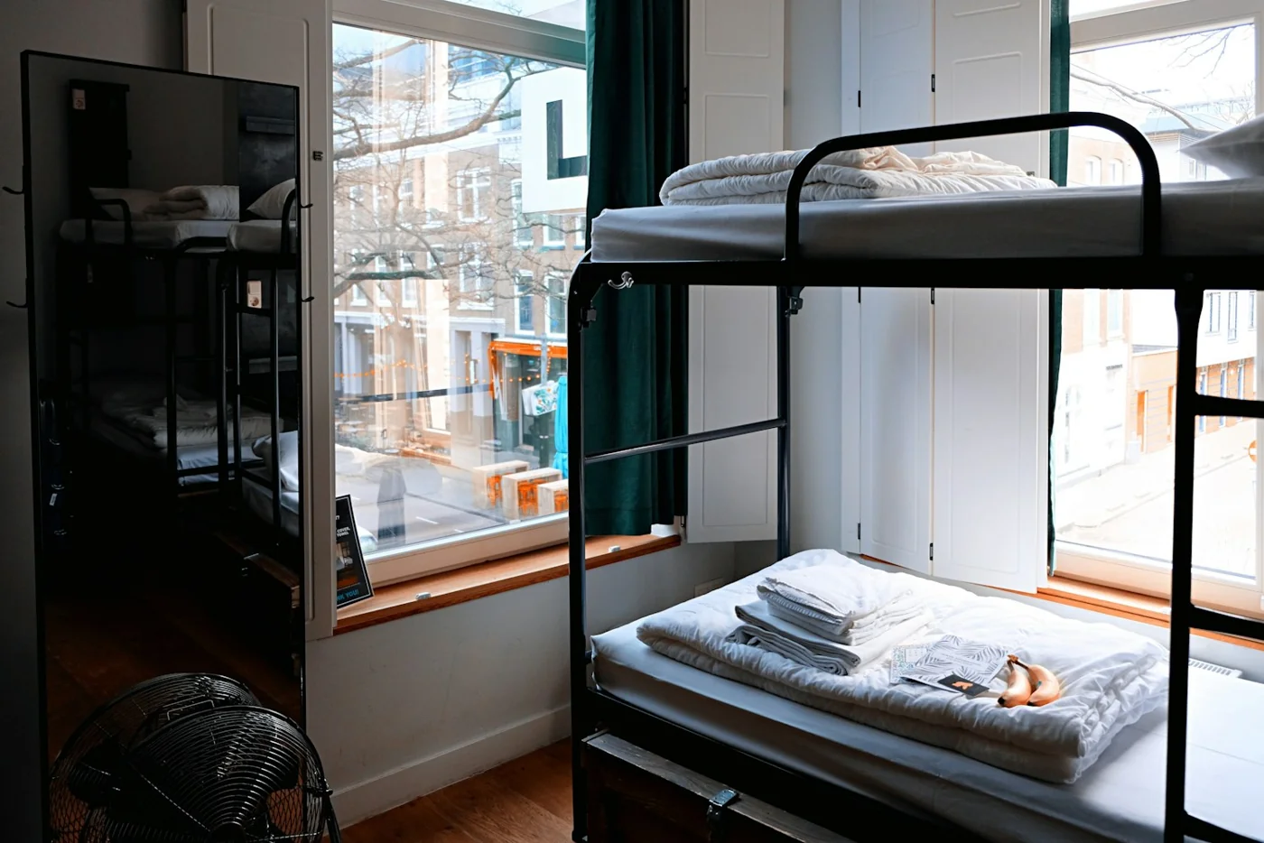 Dormitory with bunk beds and a window overlooking the city