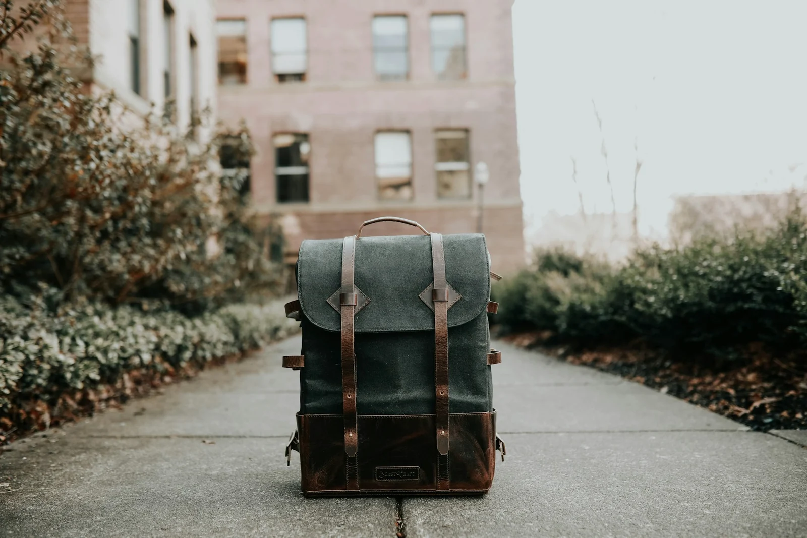 Rectangular soft backpack on a pavement; illustrative photo, dimensions not verified